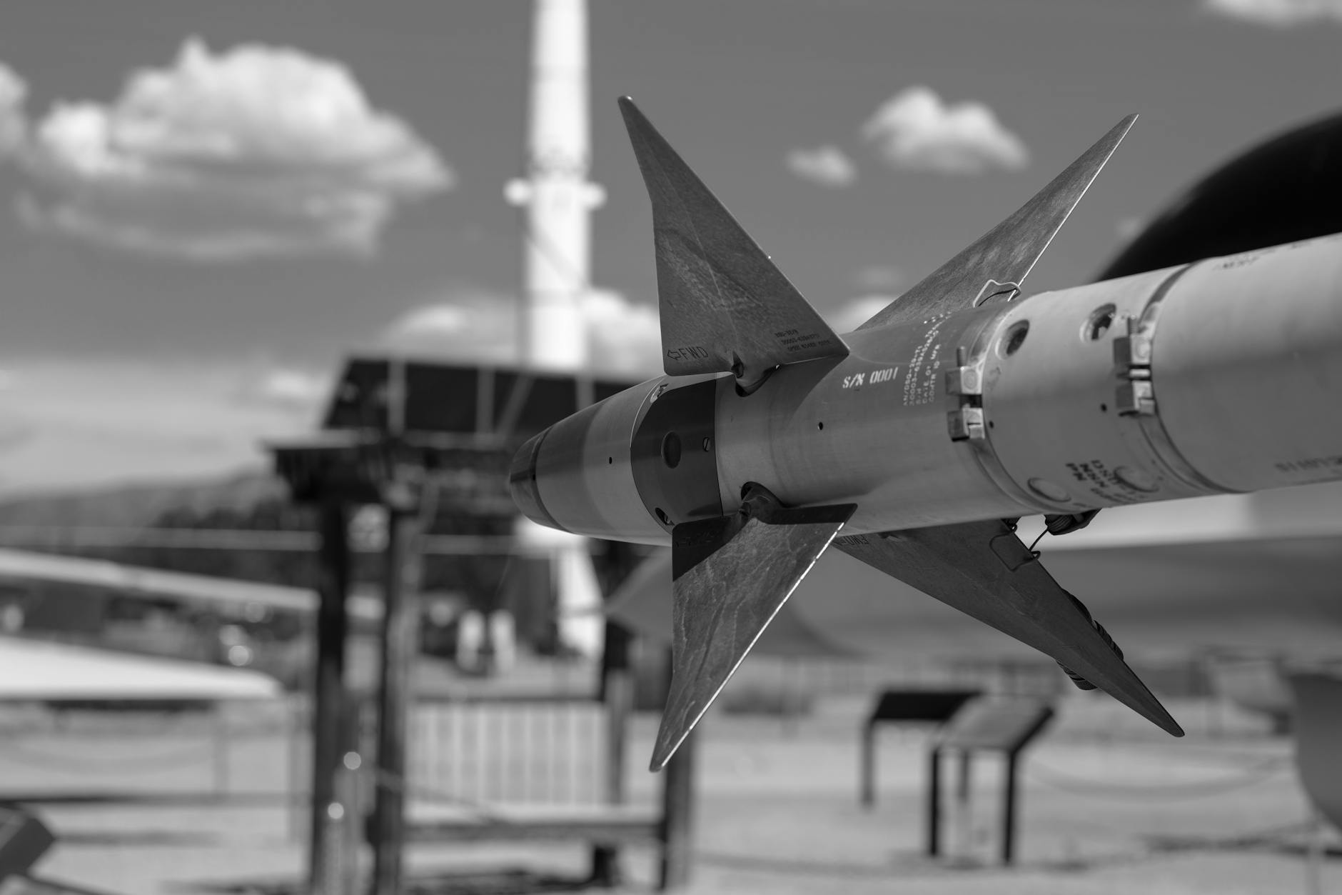 grayscale photo of airplane in missile