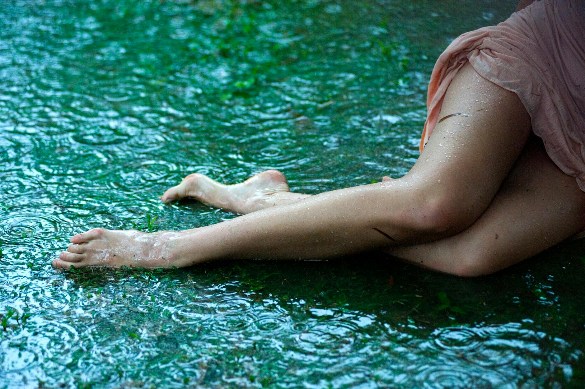 woman lying on green surface with water