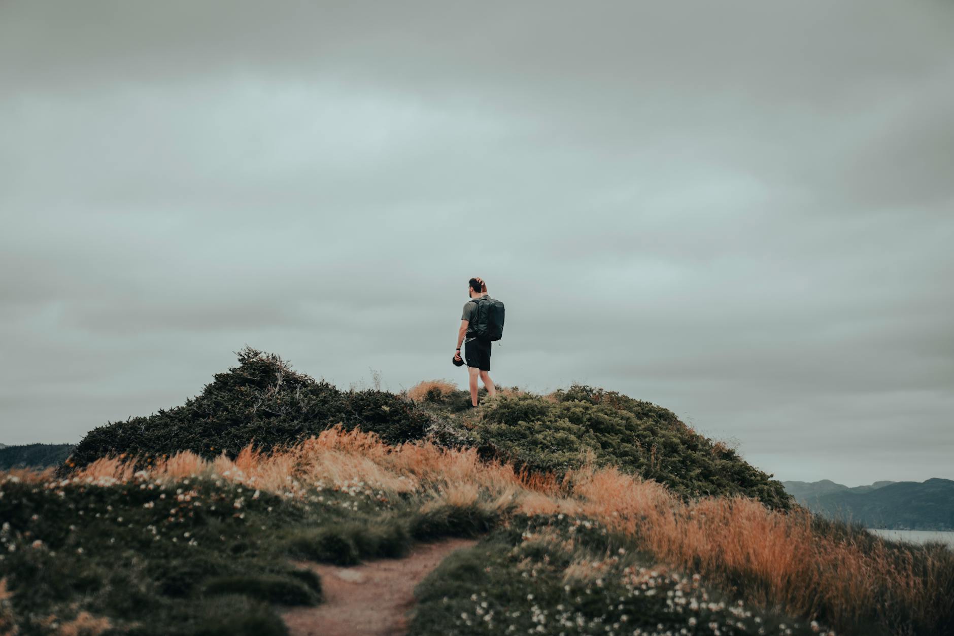 man standing on top of hill
