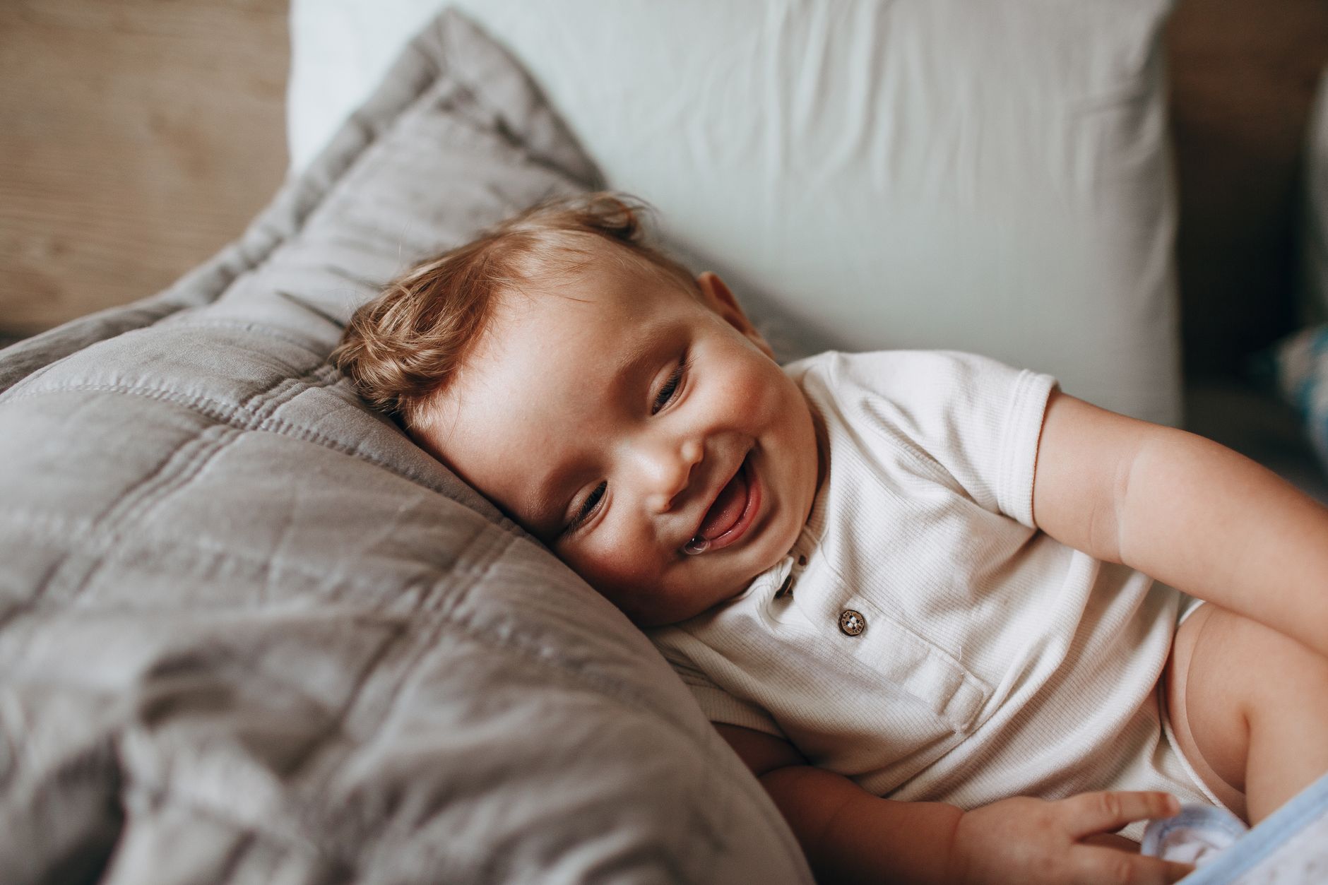 adorable baby smiling while relaxing on pillow